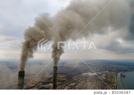 Aerial view of coal power plant high pipes with black smoke moving up polluting atmosphere. 85036387