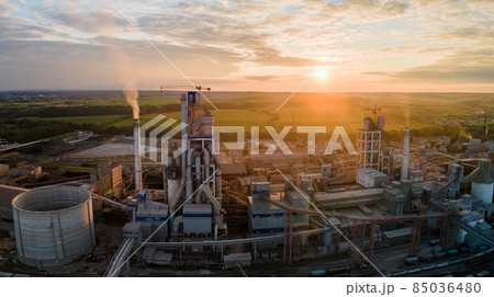 Aerial view of cement factory tower with high concrete plant structure at industrial production area. Manufacturing and global industry concept. Aerial view of cement factory tower with high concrete plant structure at industrial production area. Manufacturing and global industry concept. 85036480