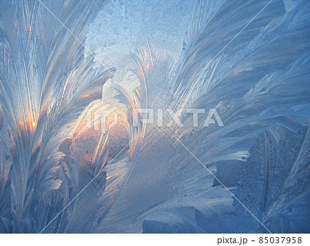 Ice pattern and sunlight closeup on window glass early in the morning 85037958