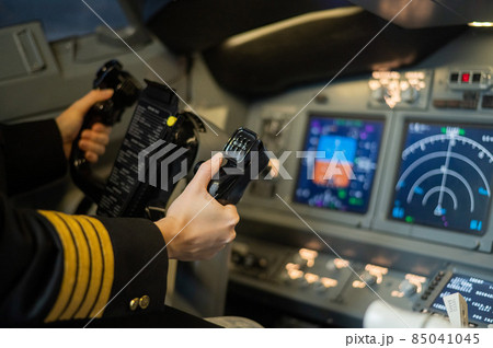 The hands of a female pilot at the helm of an airplane. Caucasian woman in flight simulator. 85041045