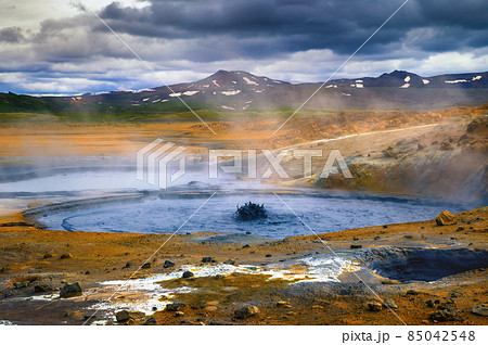 Steaming and bubbling mud pool in the Hverir geothermal area in Iceland Steaming and bubbling mud pool in the Hverir geothermal area in Iceland 85042548