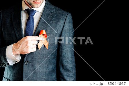 His support. Red ribbon in hiv world day in man hand. Awareness aids and cancer symbol isolated on black background. World aids day concept. 85044867