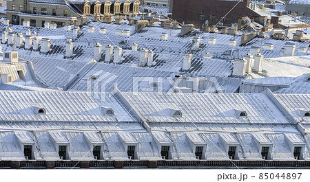 View of the white snow-covered winter roofs in the center of St. Petersburg. View of the white snow-covered winter roofs in the center of St. Petersburg. 85044897