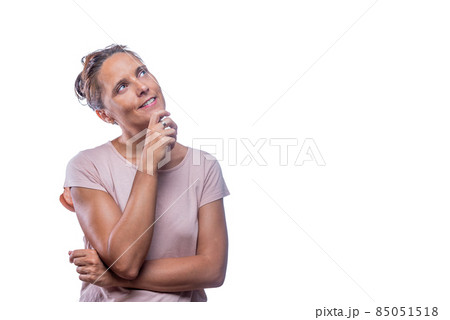 A dreamy adult woman looking up on a white background A dreamy adult woman looking up on a white background 85051518