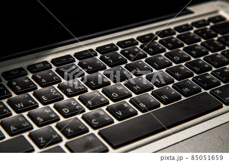 Close-up detail view of a laptop keyboard on the keys with high contrast and shallow depth of field. 85051659