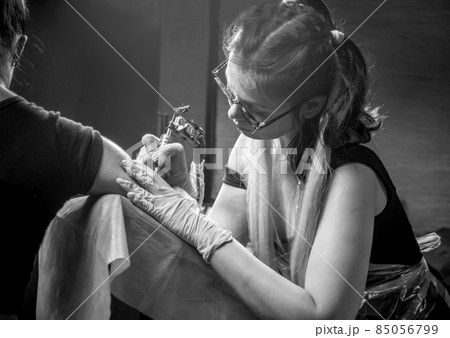 Professional tattooer posing in studio Professional tattooer posing in studio 85056799