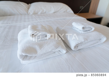Stack towel set on bed in modern bedroom at hotel Stack towel set on bed in modern bedroom at hotel 85060894