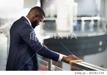 Stressed african american entrepreneur standing by railing 85061744