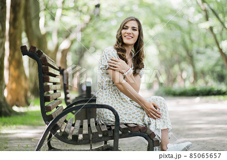 Smiling woman who lives with disability posing at park Smiling woman who lives with disability posing at park 85065657