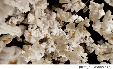Macro shot of falling popcorn on black background 85069737