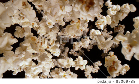 Macro shot of falling popcorn on black background Macro shot of falling popcorn on black background 85069738