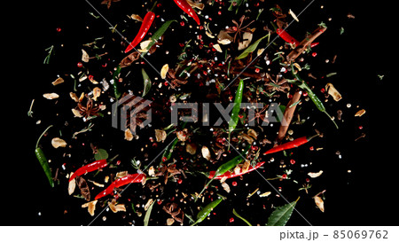 Freeze motion of flying mix of spice on black background. Freeze motion of flying mix of spice on black background. 85069762