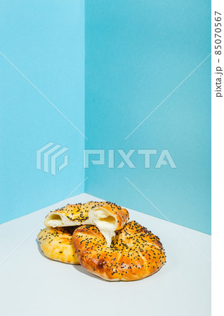 Uzbek national food Tandyr bread Lepeshka with cheese on blue background minimalistic style Uzbek national food Tandyr bread Lepeshka with cheese on blue background minimalistic style 85070567