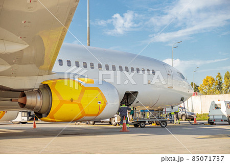 Male worker loading luggage in plane at airport 85071737