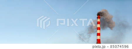 Banner. White thick smoke from the boiler room chimney. Smoke against the blue sky. Air pollution. Heating of the city. Industrial zone. 85074596