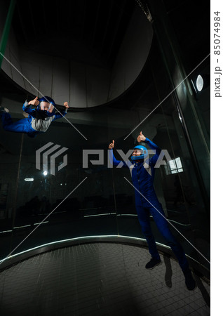 A man teaches a boy to fly in a wind tunnel. Lack of gravity. A man teaches a boy to fly in a wind tunnel. Lack of gravity. 85074984