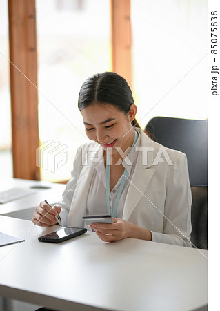 Business woman satisfied with mobile banking service. Business woman satisfied with mobile banking service. 85075838
