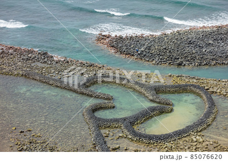 Twin Hearts Stone Weir in Penghu island Twin Hearts Stone Weir in Penghu island 85076620