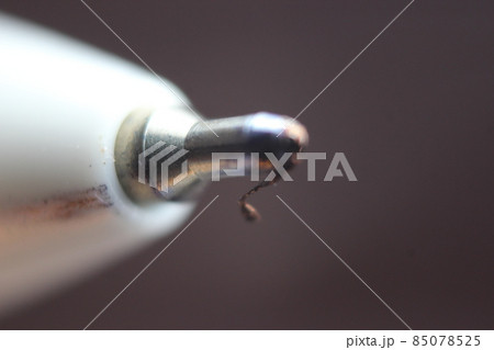 Macro photo of ballpoint pen tip with dark grey background. Macro photo of ballpoint pen tip with dark grey background. 85078525