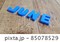 Plastic colored alphabets making words June are placed on a wooden floor 85078529