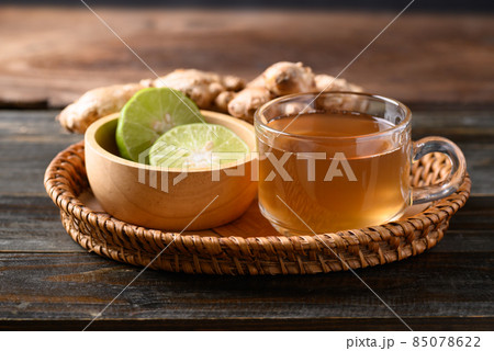 Ginger tea with lime in small basket on wooden background, Healthy herbal drink Ginger tea with lime in small basket on wooden background, Healthy herbal drink 85078622