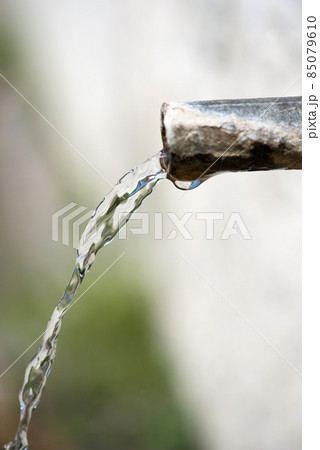 Close-up of a spout at a roadside fountain - selective focus 85079610