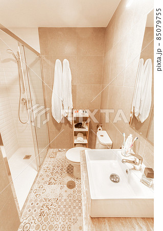 Bathroom with shower, toilet and sink with mirror from hotel 85079755