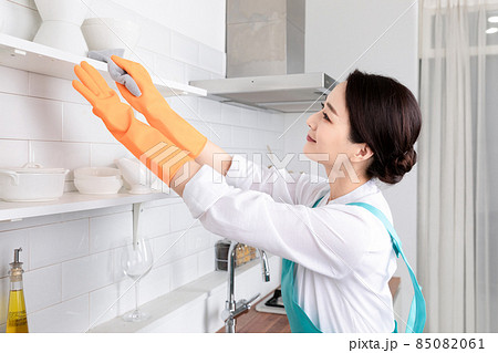 Asian woman wearing white shirt and apron, professional home cleaning service job Asian woman wearing white shirt and apron, professional home cleaning service job 85082061