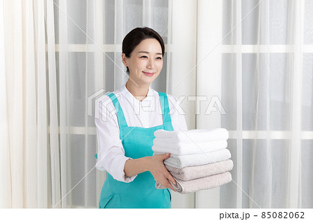 Asian woman wearing white shirt and apron, professional home cleaning service job Asian woman wearing white shirt and apron, professional home cleaning service job 85082062