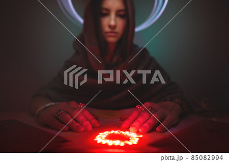 A beautiful gypsy fortune teller casts a magic spell on the drawing, predicting the future. Divine magic, Forecast of esoteric astrology, superstition, magical power, alchemy, Black magic 85082994