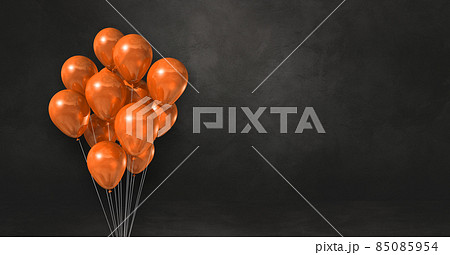 Orange balloons bunch on a black wall background. Horizontal banner. Orange balloons bunch on a black wall background. Horizontal banner. 85085954