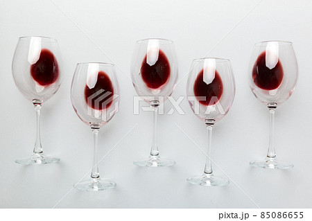 Many glasses of red wine at wine tasting. Concept of red wine on colored background. Top view, flat lay design 85086655
