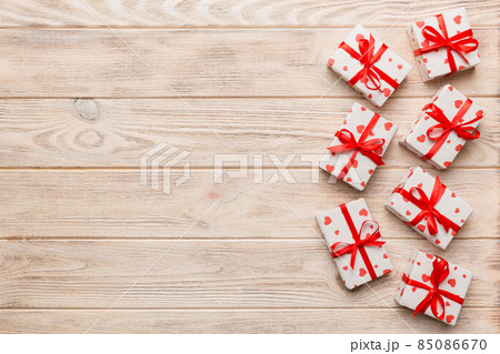 Valentine day composition: red gift box with bow and heart. Christmas present. View from above. Space for text. Holday greeting card 85086670