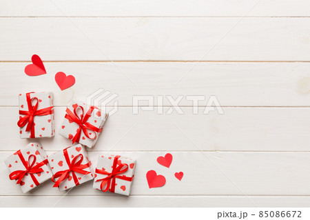Valentine day composition: red gift box with bow and heart. Christmas present. View from above. Space for text. Holday greeting card 85086672