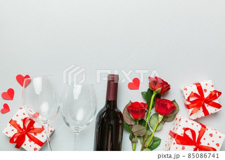 Valentine's day composition with red wine, rose flower and gift box on table. Top view, flat lay. Holiday concept 85086741