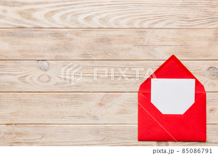Red paper envelope with empty white card and heart on colored background. top view valentines day concept 85086791