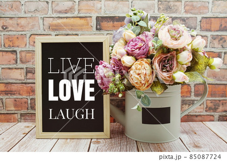 Live Love Laugh text on Blackboard and flower bouquet decoration wooden background 85087724