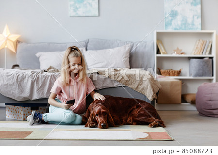 Girl with Dog at Home 85088723
