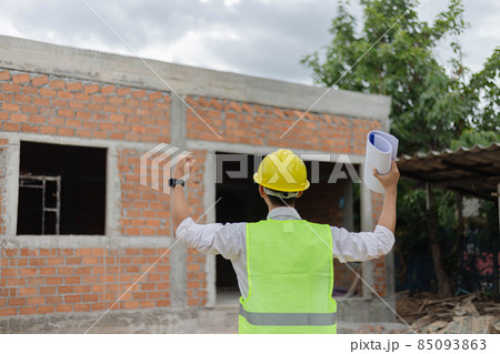 engineer concept The constructing guy looking at the construction site and raising his hands for expressing his rejoice moment 85093863