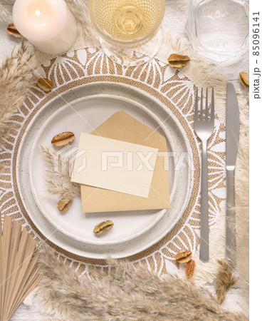 Boho Wedding Table place with Blank card over envelope near pampas grass 85096141