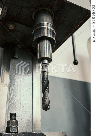 Close-up machine for drilling holes in metal. Equipment with drill for vertical drilling. Factory Close-up machine for drilling holes in metal. Equipment with drill for vertical drilling. Factory 85096703