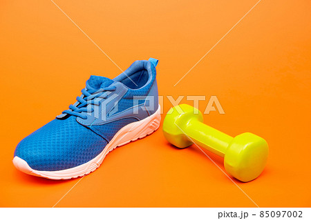 shopping concept. footwear for training. athletic footgear for running. dumbbell sport accessory. 85097002
