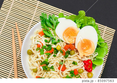 Noodle Dish with Green Pea, Carrot, Eggs, Red Hot Pepper and Greens Noodle Dish with Green Pea, Carrot, Eggs, Red Hot Pepper and Greens 85097563