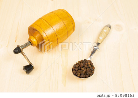 Spicy black pepper on plain wood Spicy black pepper on plain wood 85098163