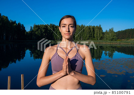 Calm young woman taking deep breath of fresh air relaxing meditating enjoying peace, serene tranquil girl doing yoga exercise feel no stress free relief 85100791
