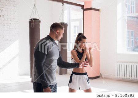 Female MMA fighter training punches technique Female MMA fighter training punches technique 85100892