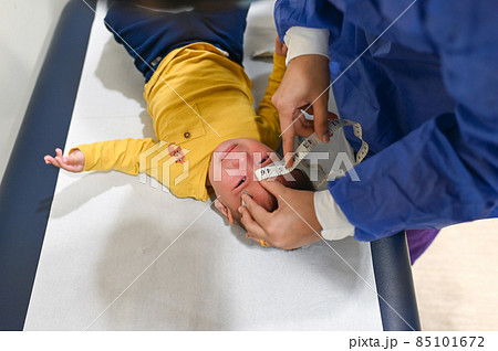 Pediatrician measuring baby boy at the doctors office for a routine checkup and physical exam to track progress at the hospital Pediatrician measuring baby boy at the doctors office for a routine checkup and physical exam to track progress at the hospital 85101672