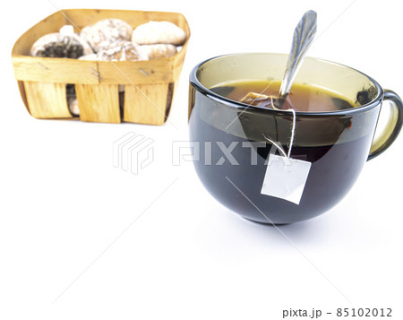 Cup of tea and cookies on a white background with free space for text. 85102012