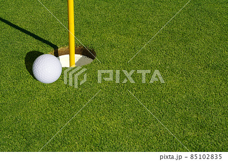 Close-up of Golf Course Green, Flag Pin and Ball. 85102835