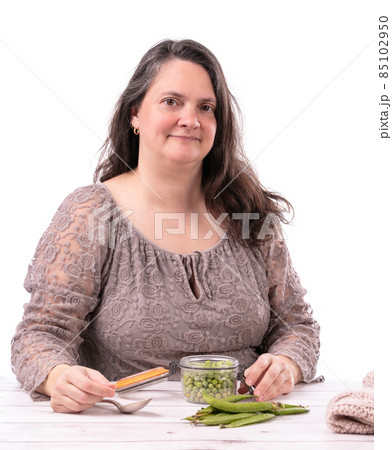 Woman with a jar of raw peas Woman with a jar of raw peas 85102950